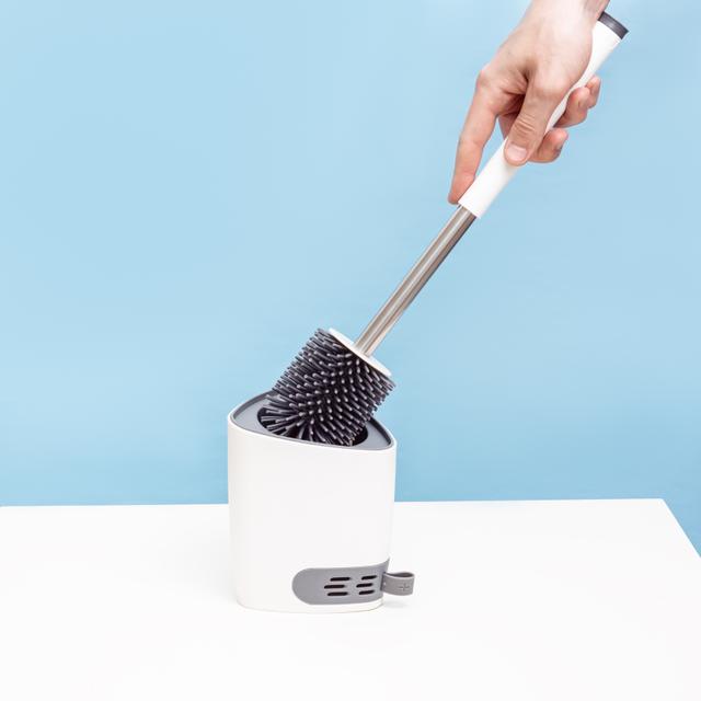Rubber toilet cleaning brush with white base on blue background